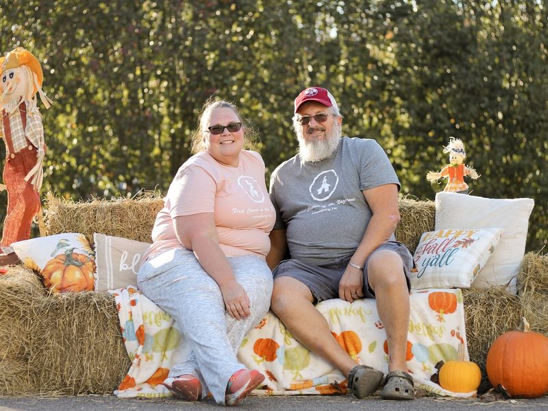 Pastors Pam and Jeff Hiatt on the hay bales at the church fall festival
